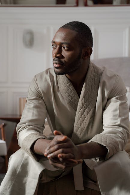 Person sits in a comfortable meditative pose in a bright, calm room