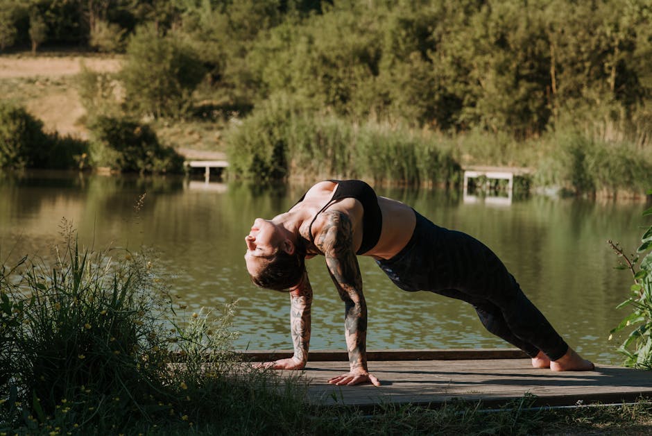 Woman practicing meditation pose on a wooden pier with beautiful nature